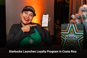 Starbucks employee poses with mobile reward program 